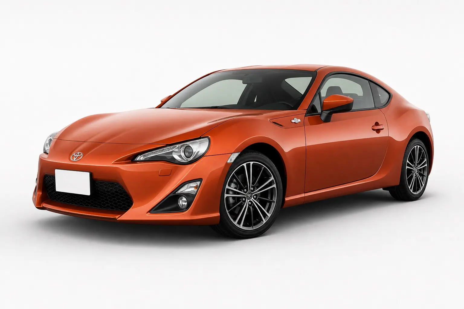 2012年式 トヨタ 86（ZN6型・前期）の斜め前からの外観。オレンジ系のボディカラー、低いノーズ、細めのヘッドランプ。背景は白い無地のスタジオ